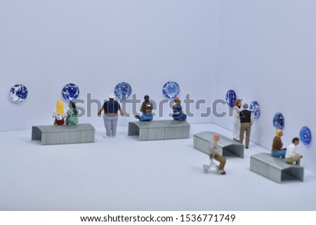 Miniature people are visiting a museum / art gallery with delft blue art
