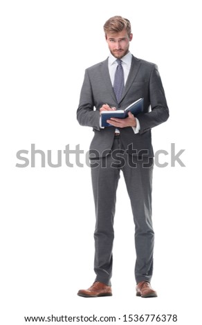 in full growth. successful businessman with a notebook.