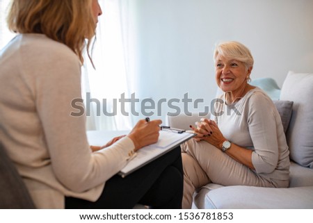 Geriatric psychology, mental therapy and old age concept - Senior woman patient and psychologist at psychotherapy session. Senior woman talking with female psychologist Royalty-Free Stock Photo #1536781853
