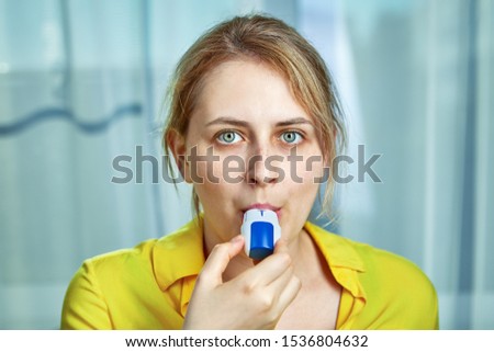 COPD or chronic obstructive pulmonary disease treatment with bronchodilator powder inhaler. A young woman uses dispenser with powders inhalation to relieve symptoms of asthma, and breathing relief. Royalty-Free Stock Photo #1536804632