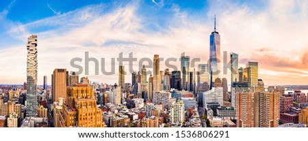 Aerial panorama of Lower Manhattan skyline at sunset viewed from above Greenwich street in Tribeca neighborhood.