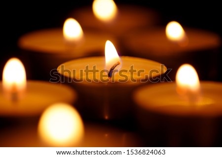 Burning candles shot with shallow depth of field on black background Royalty-Free Stock Photo #1536824063