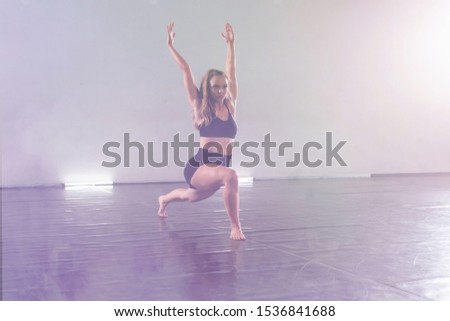 Young modern dancer dancing in the studio. Sport, dancing and urban culture concept. Group of young dancers performing on the stage. Effective performance. beautiful dance. full of energe dancers.