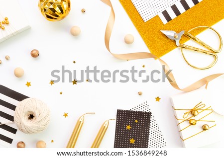 Christmas handmade gifts packing frame on white background with copy space, flat lay, top view. Mockup with twine rope, gold and black colors boxes and ribbon