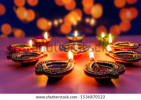 Indian festival Diwali, Diya oil lamps lit on colorful rangoli. Hindu traditional. Happy Deepavali. Copy space for text. Royalty-Free Stock Photo #1536870122