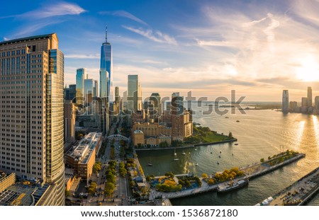 Aerial view of Lower Manhattan skyline at sunset viewed from above West Street in Tribeca neighborhood.