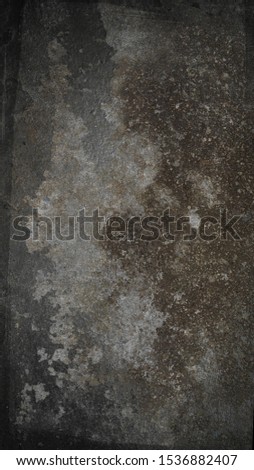 A digitally manipulated photograph of weathered cement/a dark & grungy textured overlay or wallpaper design.