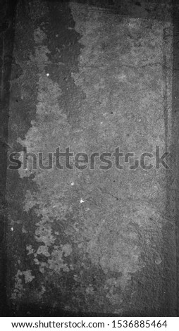 A grungy textured overlay/black & grey aged stone wallpaper design with a scratchy border.