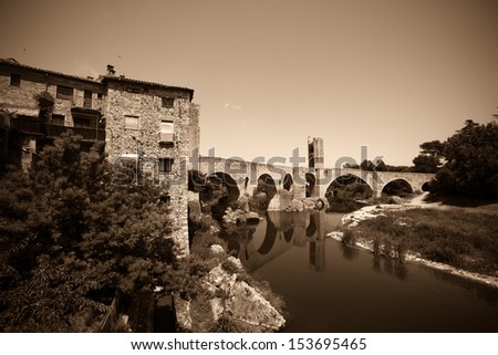 Vintage photo of old  bridge over Fluvia river. Besalu, Catalonia