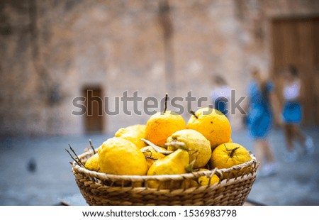 Yellow organic Lemons in a hand made basket with a blurred background