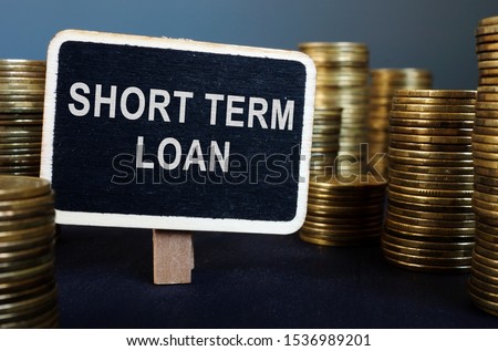 Short term loan inscription and stack of coins. Royalty-Free Stock Photo #1536989201