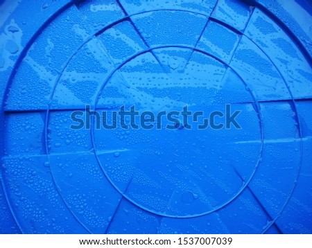 Abstract Blue Plastic sheet material with monsoon rain drops on it. 