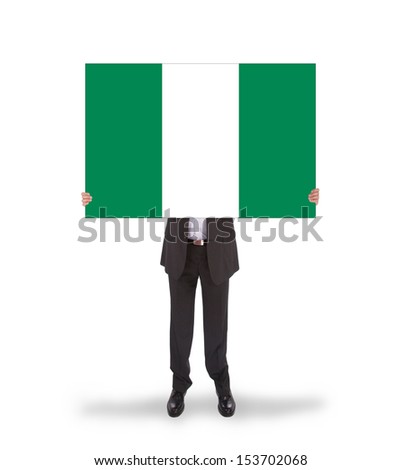 Businessman holding a big card, flag of Nigeria, isolated on white