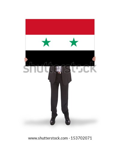 Businessman holding a big card, flag of Syria, isolated on white