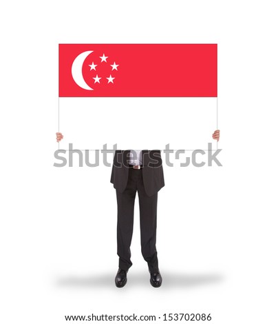 Businessman holding a big card, flag of Singapore, isolated on white