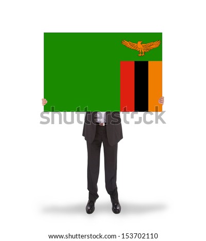 Businessman holding a big card, flag of Zambia, isolated on white