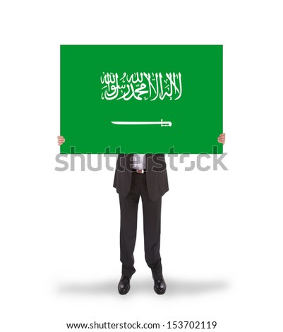 Businessman holding a big card, flag of Saudi Arabia, isolated on white