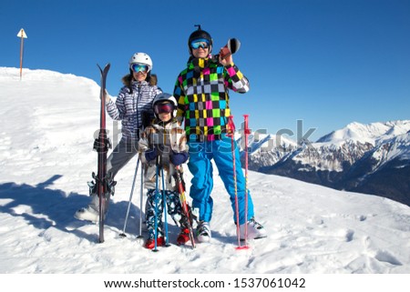 Portrait of a sporting family in equipment at a ski resort