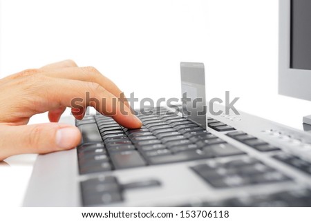 Male hand using computer and credit card for online payment