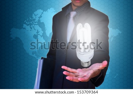 eco lamp in hand businessman on blue map background
