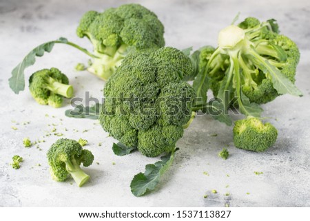 Fresh green broccoli on a light grey background. Macro photo green fresh vegetable broccoli. Green Vegetables for diet and healthy eating. Organic food.
