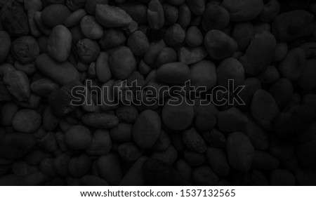 Black pebble stones texture background. Can be use for your design, advertising, backdrop, product display or montage