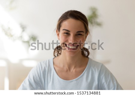Head shot close up portrait overjoyed young mixed race woman posing fpr photo. Happy smiling sincere multiracial millennial lady looking at camera. Positive face expression, good mood concept.