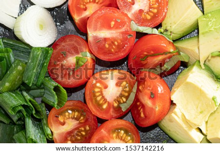 Salad - avocado, spring onion and tomato stock photo. Top View