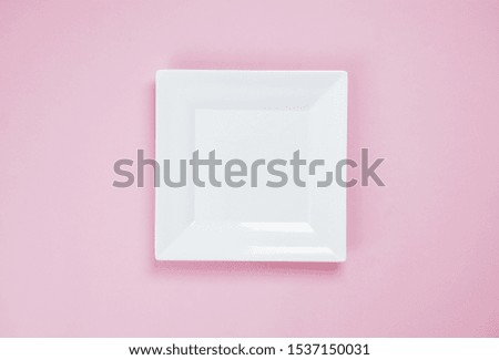 White dish on a pink background