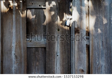 The wooden door with a combination padlock