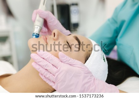 Close-up of woman getting facial hydro microdermabrasion peeling treatment. Female at cosmetic beauty spa slinic. Hydra vacuum cleaner. Cosmetology Royalty-Free Stock Photo #1537173236