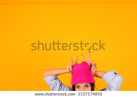woman in hat shows fingers horns isolated background advertisement banner place free