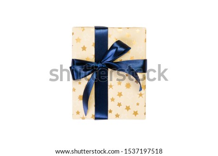 Christmas or other holiday handmade present in gold paper with blue ribbon. Isolated on white background, top view. thanksgiving Gift box concept. Royalty-Free Stock Photo #1537197518