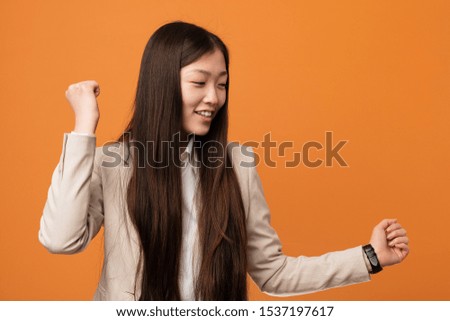 Young business chinese woman dancing and having fun.