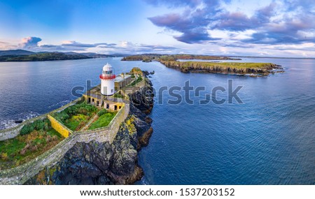 Aerial of the Rotten Island Lighthouse with Killybegs in background - County Donegal - Ireland.