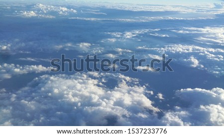 Picture from an airplane taken why flying above the clouds.