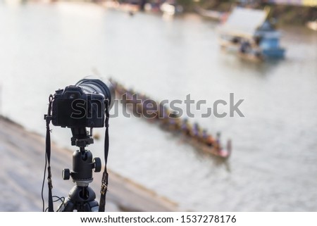 Cameras with a large telephoto lens  zoom take a photos the long-boat competition is a local tradition that has been passed on for decades.