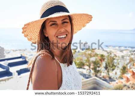 Beautiful young woman walking on beach promenade enjoying ocean view smiling happy on summer vacation