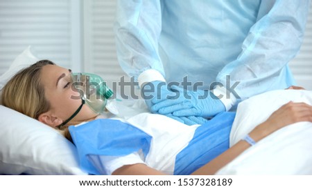 Doctor making cardiopulmonary resuscitation to female patient, reanimation Royalty-Free Stock Photo #1537328189