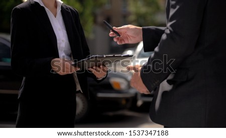 Male agent giving pen to female business partner, signing contract, service deal