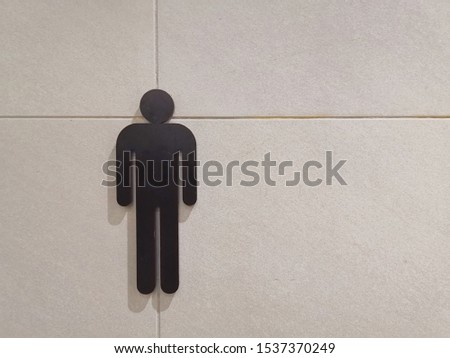 Male toilet sign at the shopping mall. Low light image.