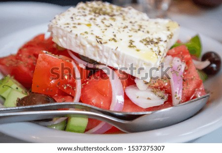 Greek salad with fresh vegetables and feta cheese, closeup view. Healthy diet, organic food