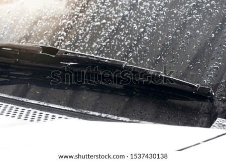 Wiper of cars on glass floors with water droplets.