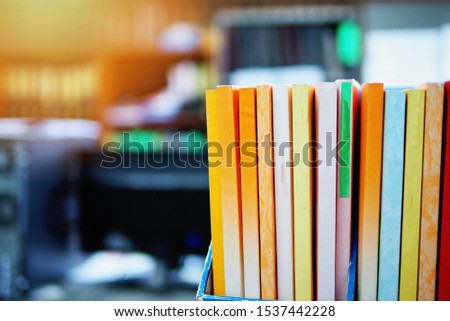 Books on a book shelf in the office, selective focused picture of colorful reports or books, business or educational concept image.