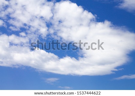 Blue sky with cirrus and cumulus clouds.
