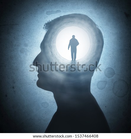 A silhouete of a man with rays of light emanating from the brain as a symbol of the power of thinking. Concept on the topic of psychiatry (bipolar disorder, schizophrenia), psychology, religion. Royalty-Free Stock Photo #1537466408