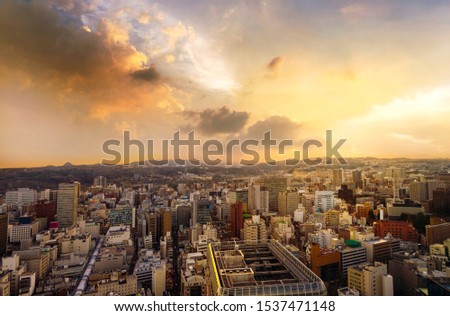 Cityscape of miyagi, city aerial skyscraper view of office building and downtown of sendia with sunset rays of light shining down pass clouds background. Japan, Asia