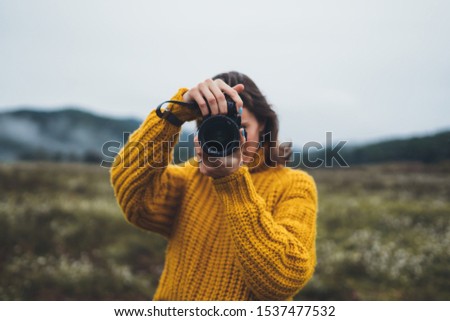 photographer tourist take photo on camera lens on background autumn foggy mountain, traveler hipster shooting video nature mist landscape, hobby vacation concept, copy space