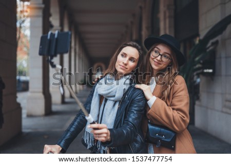 Girlfriends tourist taking photo selfie together on smartphone mobile. Blogger travels in europe city. Vacation holiday friendship concept. Travelers self on cellphone internet technology mockup space