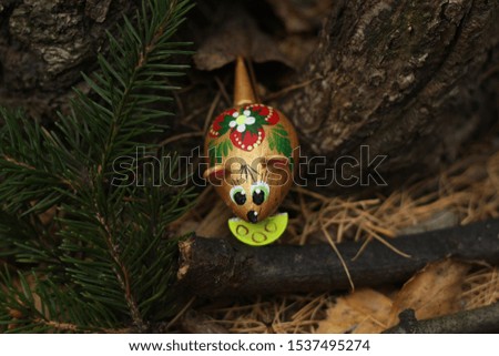painted mouse on the background of the christmas tree